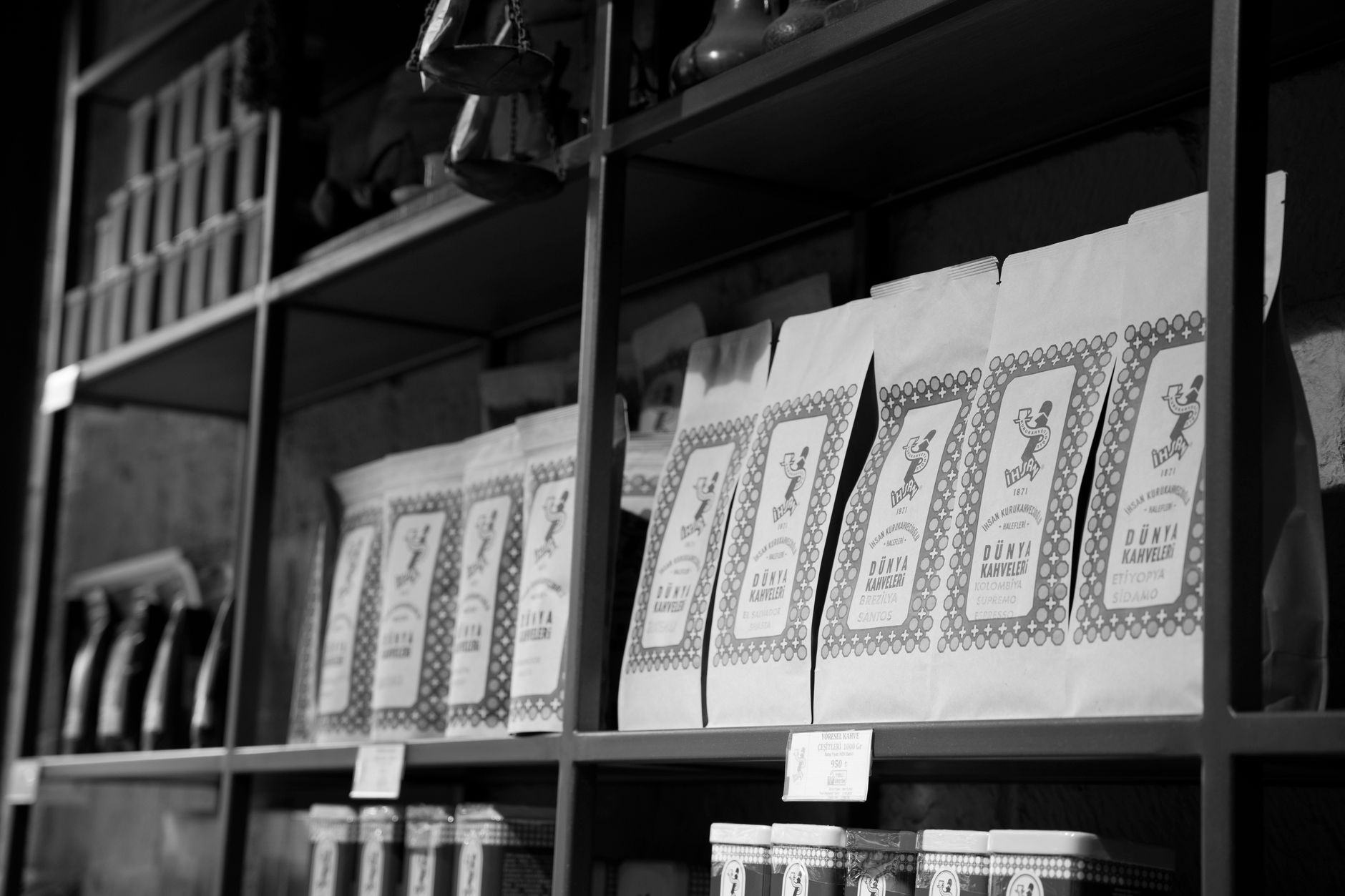 Bags of Kimbo, Borbone, and Passalacqua coffee lined up on a shelf