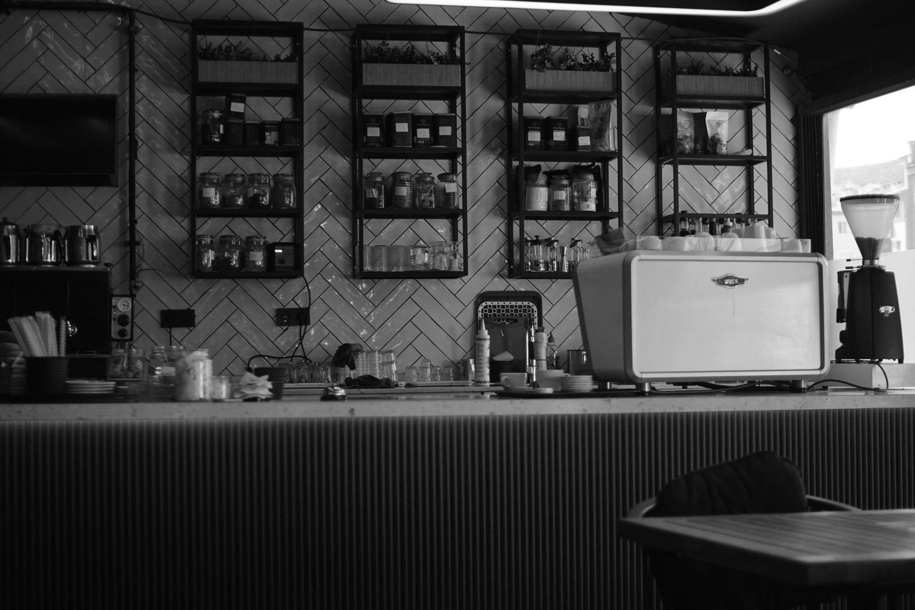 A historic black-and-white style photo of a Naples café counter