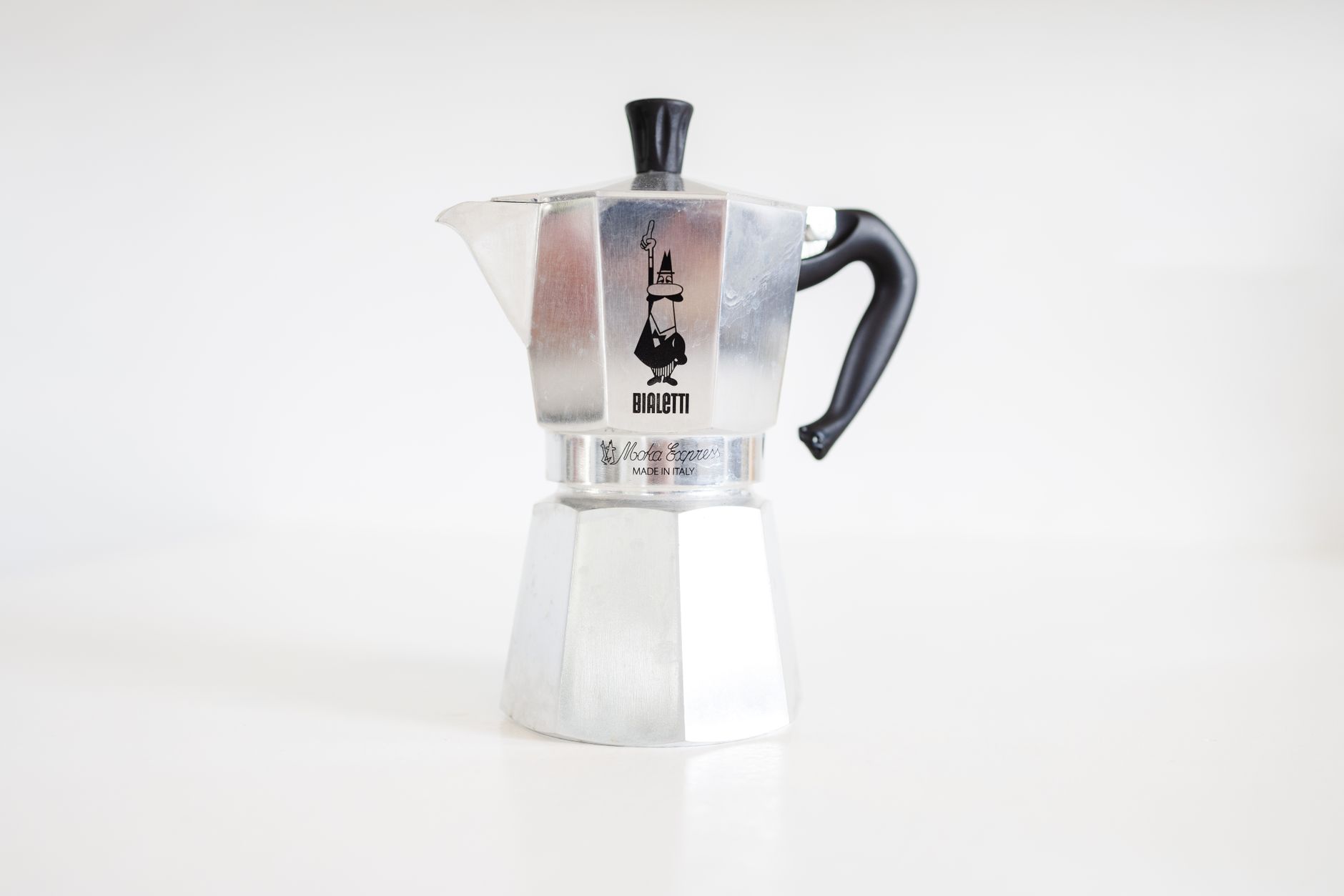 A cuccumella and a moka pot side by side on a gas stovetop