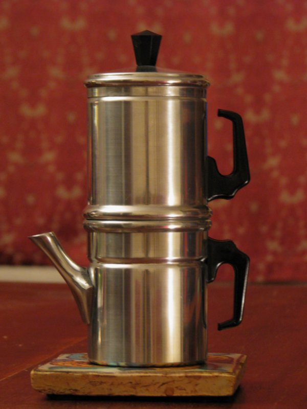 A disassembled cuccumella: water chamber, filter, and spouted collecting chamber