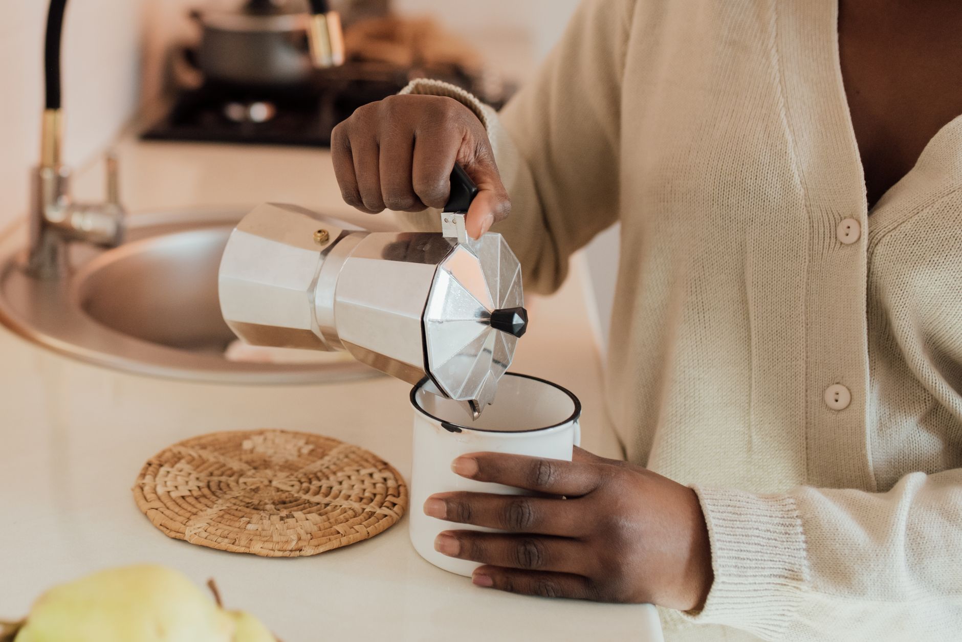A moka pot and a cuccumella next to each other on a kitchen counter