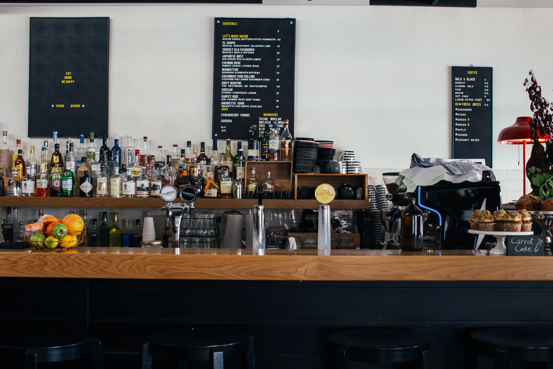 A hand pointing at an espresso menu board in a Neapolitan bar