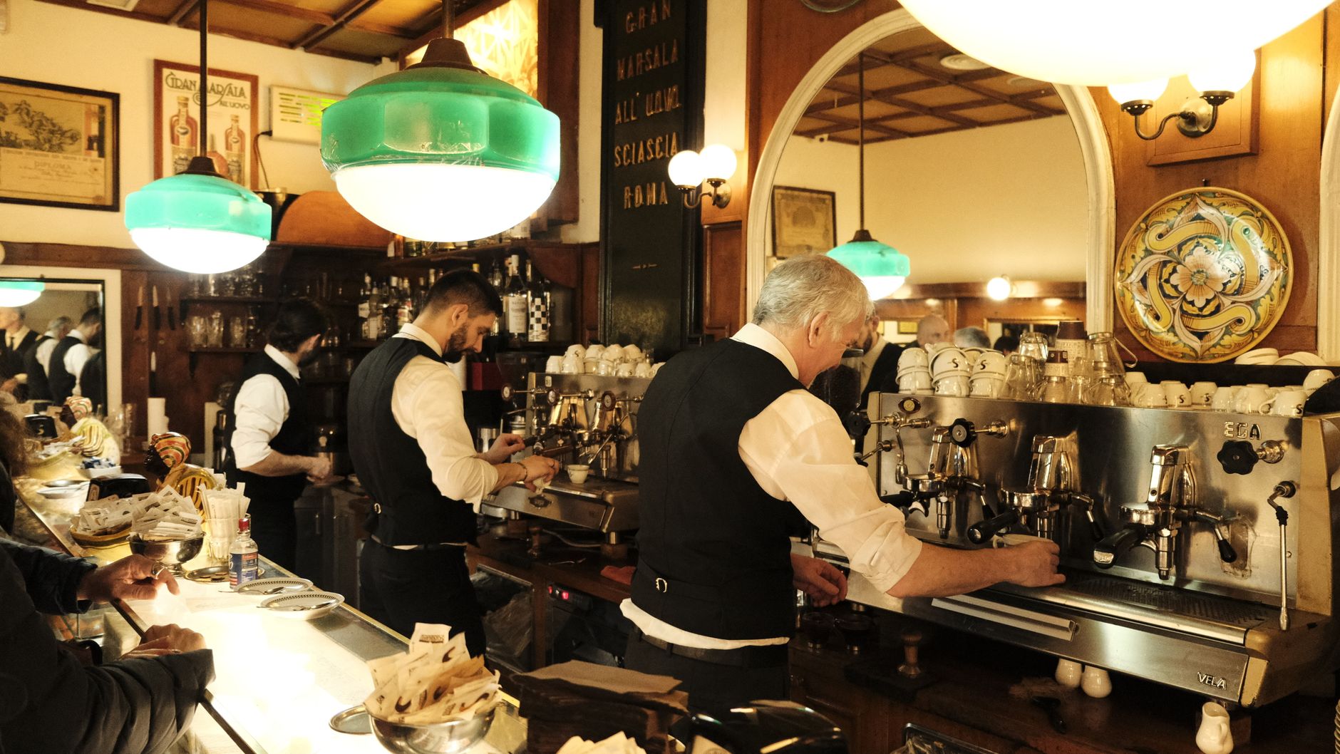 An old photograph-style scene of friends sharing coffee at a Neapolitan bar counter