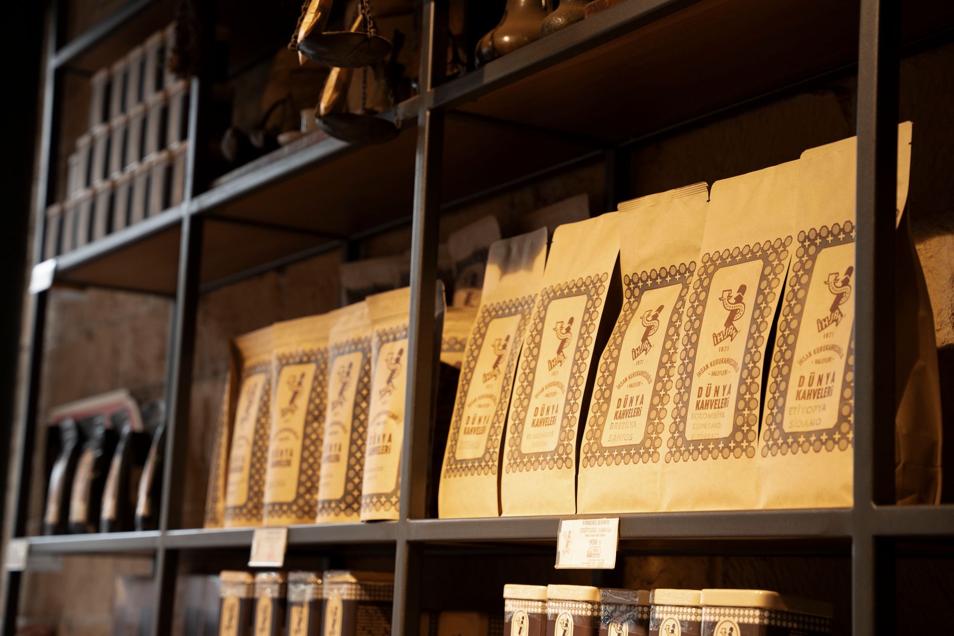 Bags of Kimbo, Borbone, and Passalacqua coffee lined up on a shelf
