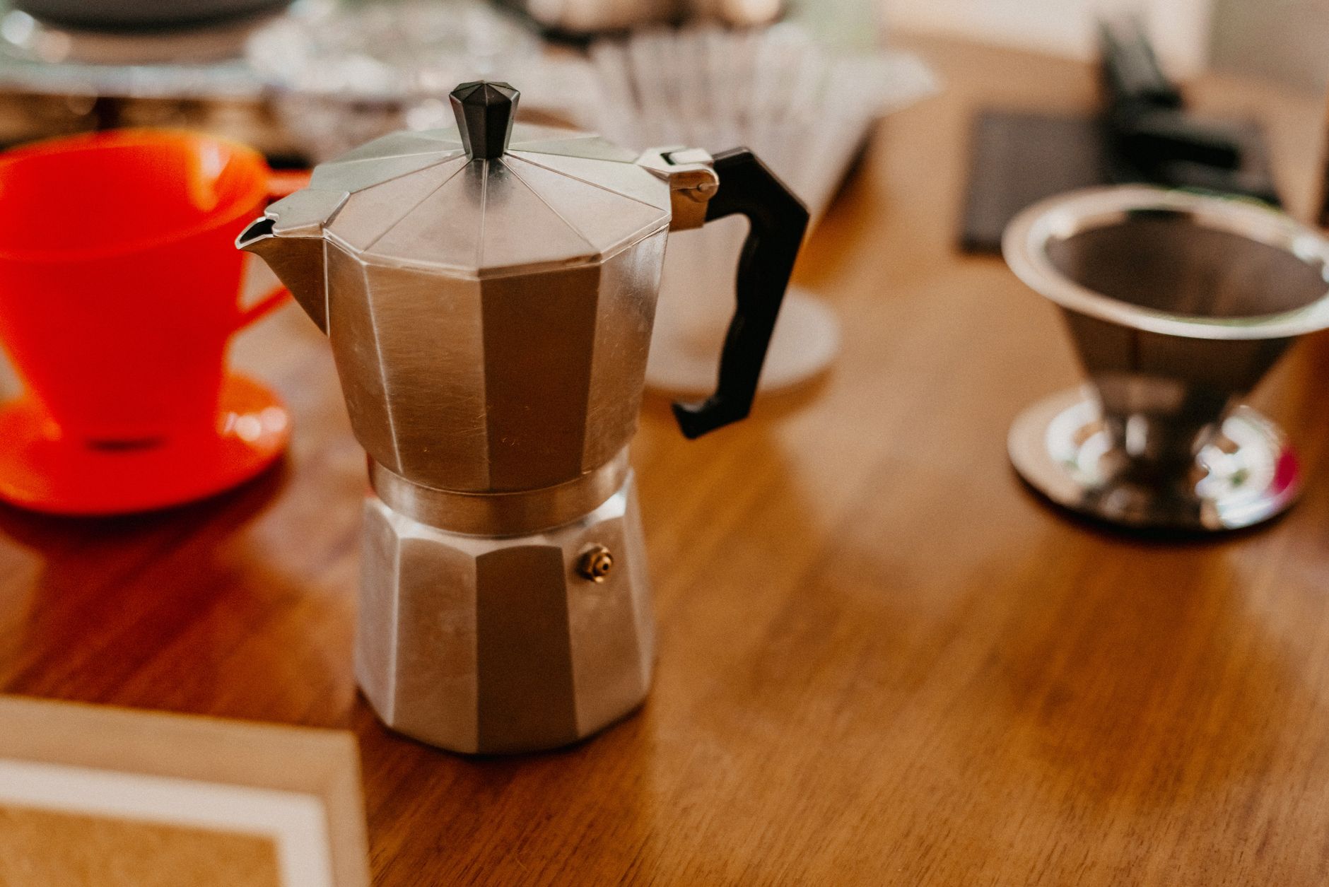 A cuccumella, a moka pot, and a bag of coffee laid out for a buying-guide photo